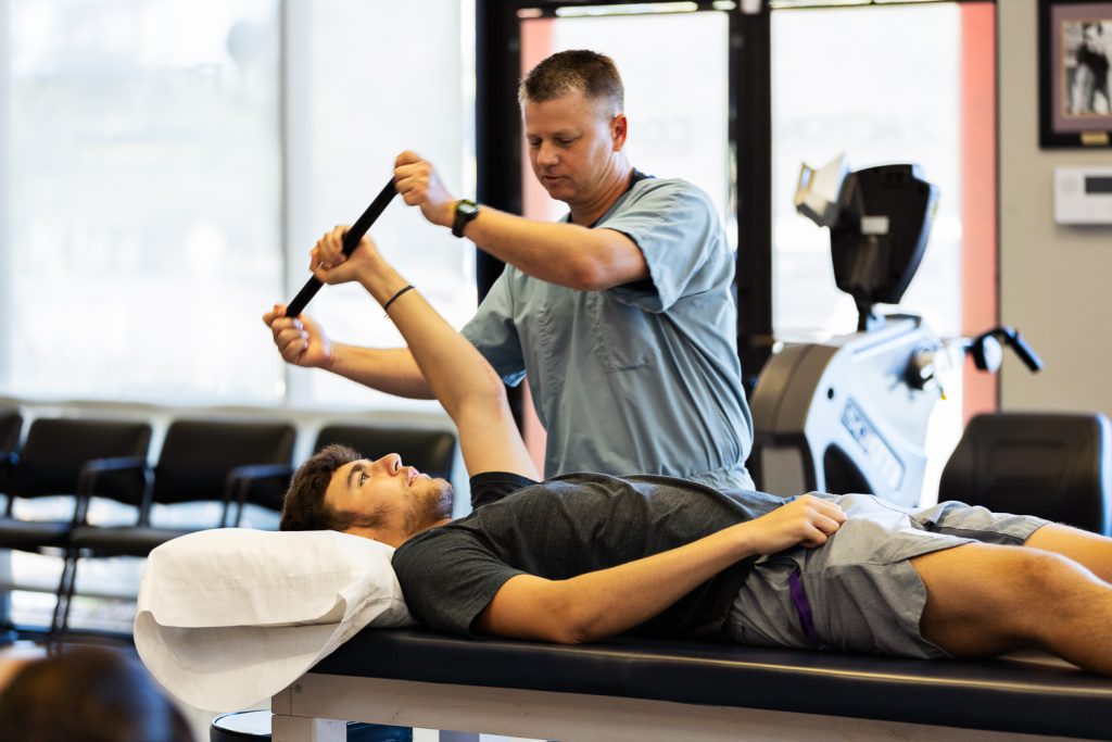 Physical Therapist working on Patient with Shoulder pain in slidell